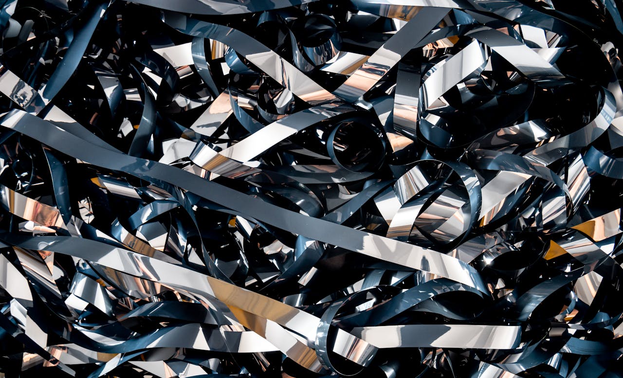 A detailed close-up of tangled magnetic tape ribbons creating a complex abstract pattern.
